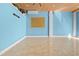 Empty room with glossy tile floors, blue walls, wood ceiling and recessed lighting at 6633 Driftwood Dr, Hudson, FL 34667