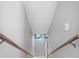 Stairway going into unfinished basement shows wood railings and grey walls at 6633 Driftwood Dr, Hudson, FL 34667
