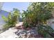 Landscaped backyard featuring tropical plants and a charming pathway at 6712 W Clifton St, Tampa, FL 33634