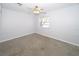 Bedroom with a ceiling fan, and a window providing natural light and a view of the outside at 6712 W Clifton St, Tampa, FL 33634