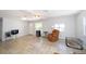 Spacious living room with neutral tile flooring, bright natural light, and ample space for seating arrangements at 6712 W Clifton St, Tampa, FL 33634