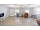 Spacious living room with neutral tile flooring, bright natural light, and ample space for seating arrangements at 6712 W Clifton St, Tampa, FL 33634