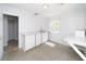 Bright room with a window, a sink, marble countertops, and white cabinets at 6712 W Clifton St, Tampa, FL 33634