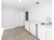 Bright room with white cabinets, marble countertops, and speckled floors at 6712 W Clifton St, Tampa, FL 33634