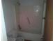 Enclosed bathtub with shower and toilet at 710 E 129Th Ave, Tampa, FL 33612