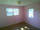 Bedroom features two windows that provide natural light and air flow into the room at 710 E 129Th Ave, Tampa, FL 33612