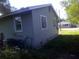 Corner of house with siding, windows, and an external AC unit at 710 E 129Th Ave, Tampa, FL 33612