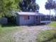 A single-story home with siding, front porch and metal roof on a sunny day at 710 E 129Th Ave, Tampa, FL 33612