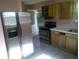 Open kitchen view with stainless steel refrigerator and gas range oven at 710 E 129Th Ave, Tampa, FL 33612