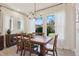 Dining room with large windows, wooden table, and chairs, perfect for Gathering gatherings at 7506 Sea Lilly Ct, Apollo Beach, FL 33572