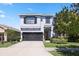 Charming two-story home featuring a well-maintained lawn, two-car garage, and lovely landscaping at 7506 Sea Lilly Ct, Apollo Beach, FL 33572