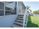 Backyard stairs with access to the lanai and patio area with view of the yard at 819 Birdie Way, Apollo Beach, FL 33572