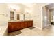 Bright bathroom featuring a double sink vanity with granite countertop and tile flooring at 819 Birdie Way, Apollo Beach, FL 33572