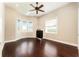 Bedroom with hardwood floors, ceiling fan, and lots of natural light at 819 Birdie Way, Apollo Beach, FL 33572