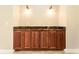 Built-in cabinetry featuring rich wood and marble counter, complemented by sconce lighting at 819 Birdie Way, Apollo Beach, FL 33572