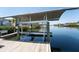 Waterfront property featuring a private boat lift and dock, providing convenient access to the water at 819 Birdie Way, Apollo Beach, FL 33572