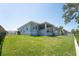 Wide backyard view, showcasing a lush lawn, screened patio and side yard fencing, offering a secure and private outdoor space at 819 Birdie Way, Apollo Beach, FL 33572