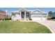 Beautiful home with a manicured lawn, well-maintained landscaping, and a grand entrance at 819 Birdie Way, Apollo Beach, FL 33572