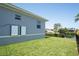 Green lawn in the side yard, adjacent to a privacy fence, offering beautiful water views and enhancing property appeal at 819 Birdie Way, Apollo Beach, FL 33572