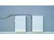 Two white Tesla powerwalls provide energy storage in the exterior view, supporting modern sustainable living at 819 Birdie Way, Apollo Beach, FL 33572