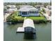Waterfront home with a boat lift and a covered dock, blending comfort and convenience for the discerning homeowner at 819 Birdie Way, Apollo Beach, FL 33572
