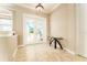 Bright foyer with tile flooring, a decorative table, and an elegant front door at 819 Birdie Way, Apollo Beach, FL 33572