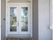 Elegant double front doors featuring decorative glass panels and a secure entryway at 819 Birdie Way, Apollo Beach, FL 33572