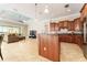 Open-concept kitchen featuring granite countertops, custom cabinets, and views of the living area at 819 Birdie Way, Apollo Beach, FL 33572