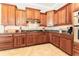 Gourmet kitchen with custom wood cabinets, granite countertops, and a gas range at 819 Birdie Way, Apollo Beach, FL 33572