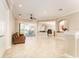 Open-concept living room with tile flooring and access to a screened-in pool area at 819 Birdie Way, Apollo Beach, FL 33572