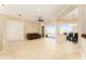 Bright living room with tile floors, ceiling fan, and sliding glass doors to the outdoor pool area at 819 Birdie Way, Apollo Beach, FL 33572