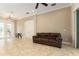 Spacious living room featuring tile floors, crown molding, and access to the foyer at 819 Birdie Way, Apollo Beach, FL 33572