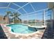 Inviting pool area with attached spa in a screened enclosure, providing a relaxing outdoor experience at 819 Birdie Way, Apollo Beach, FL 33572