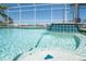 Beautiful pool with a tiled spa featuring a waterfall, creating a luxurious and serene atmosphere at 819 Birdie Way, Apollo Beach, FL 33572