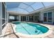 Lovely pool and spa surrounded by a paved patio and lanai, perfect for enjoying the outdoors at 819 Birdie Way, Apollo Beach, FL 33572