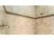 Shower with decorative band, tile surround, and brushed metal fixtures at 819 Birdie Way, Apollo Beach, FL 33572