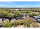 Aerial view of homes, mature trees and a lake in the background at 8528 Quarter Horse Dr, Riverview, FL 33578