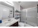 Bathroom showcasing a modern vanity, updated shower, and practical shelving for storage at 8528 Quarter Horse Dr, Riverview, FL 33578