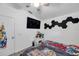 Well-lit bedroom featuring a ceiling fan, and unique hexagonal wall decor at 8528 Quarter Horse Dr, Riverview, FL 33578