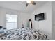 Bright bedroom featuring a ceiling fan, large windows, and a mounted TV at 8528 Quarter Horse Dr, Riverview, FL 33578