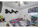 Vibrant bedroom with custom wall art, a ceiling fan, and a dedicated shoe rack at 8528 Quarter Horse Dr, Riverview, FL 33578