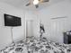 Bright bedroom featuring a ceiling fan, closet, and a mounted TV at 8528 Quarter Horse Dr, Riverview, FL 33578
