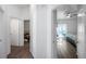 Hallway features wood-look flooring and views to the bedrooms at 8528 Quarter Horse Dr, Riverview, FL 33578