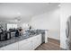 Open kitchen featuring granite counters, a stainless dishwasher, and seamless access to the living space at 8528 Quarter Horse Dr, Riverview, FL 33578