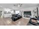 Open-concept living room with plank floors, ceiling fan, and comfortable seating at 8528 Quarter Horse Dr, Riverview, FL 33578