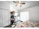 Bedroom features a ceiling fan, wood-look floors, and a walk-in closet at 8528 Quarter Horse Dr, Riverview, FL 33578