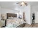 Bedroom features a ceiling fan, wood-look floors, and an en-suite bathroom at 8528 Quarter Horse Dr, Riverview, FL 33578
