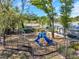 Community playground with a blue slide, monkey bars, and a fenced-in area for safety and fun at 8528 Quarter Horse Dr, Riverview, FL 33578