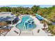 An aerial view of a community pool with a water slide, lounge chairs, and covered seating area at 8528 Quarter Horse Dr, Riverview, FL 33578