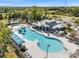 Community pool featuring a water slide, covered seating, clubhouse, and lounge chairs at 8528 Quarter Horse Dr, Riverview, FL 33578